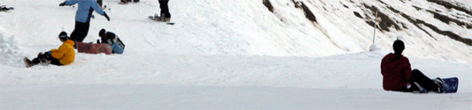 Snowboarders on asses